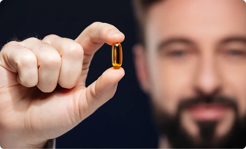 Man holding softgels